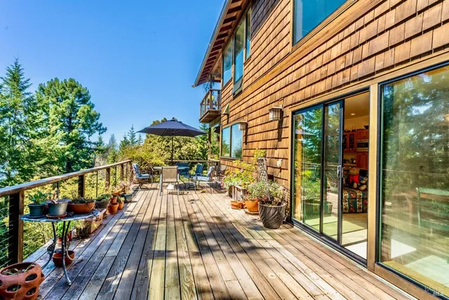 a dining room with furniture water view and a floor to ceiling window
