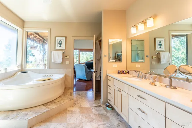 a living room with furniture a flat screen tv and a floor to ceiling window