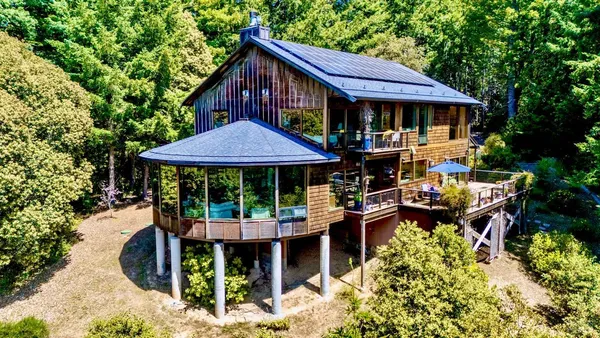 a view of a table and chairs under an umbrella in the patio