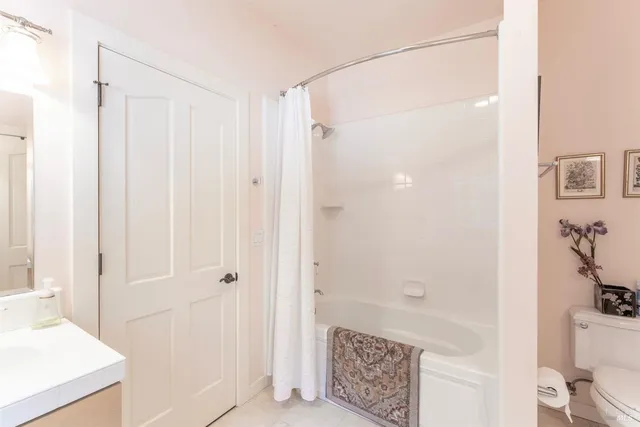 a living room with furniture a rug and a floor to ceiling window