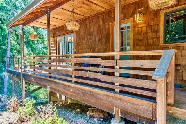 a view of a house with a large window and wooden fence