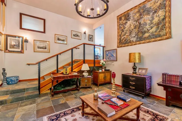 a living room with furniture and a mirror