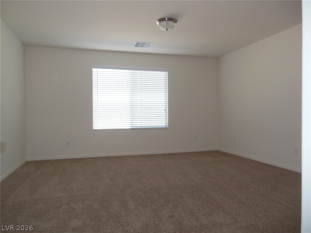 6390 Jackson Spring Road Las Vegas, NV 89118 - Photo 19 of 27 An airy room offers a comfortable canvas for personalization with neutral tones and carpet.