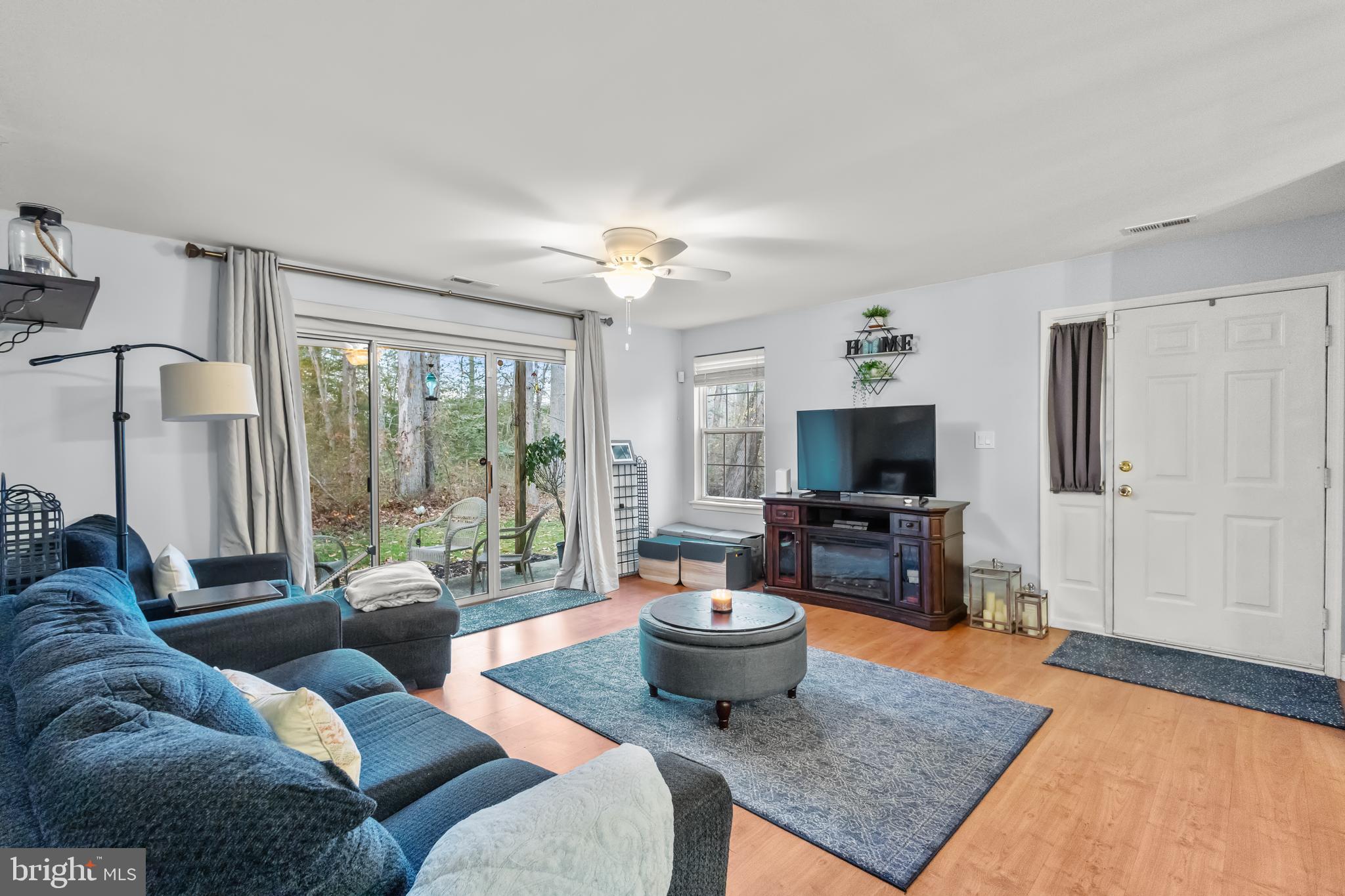 705 Quail Road Marlton, NJ 08053 - Photo 4 of 13 a living room with furniture a flat screen tv and a large window