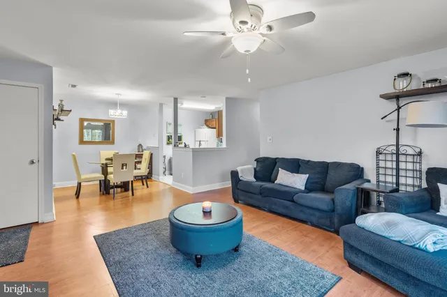 a living room with furniture and a dining table