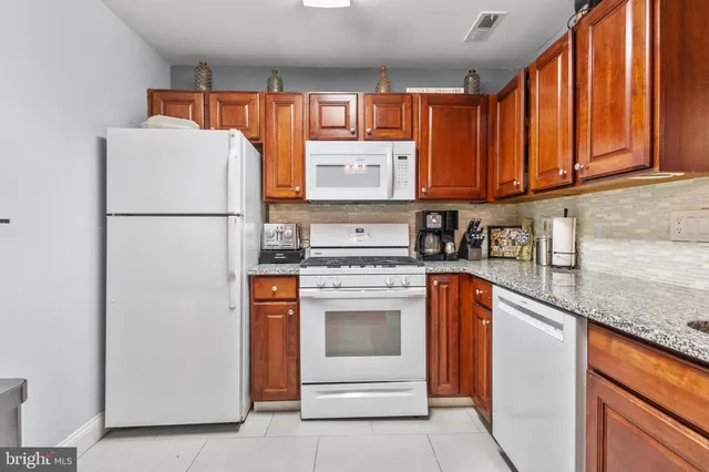 a kitchen with a refrigerator sink and cabinets