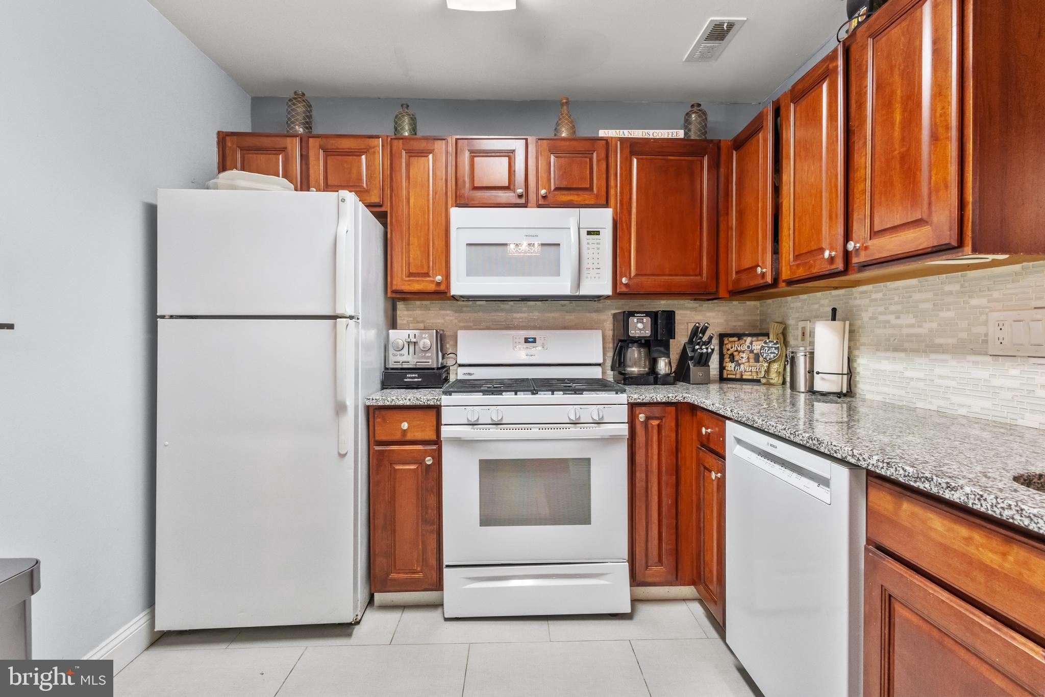 705 Quail Road Marlton, NJ 08053 - Photo 7 of 13 a kitchen with a refrigerator sink and cabinets