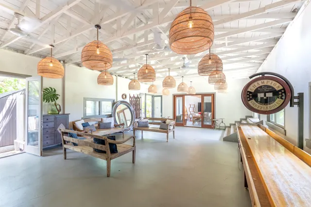 a living room with furniture a clock and a large window