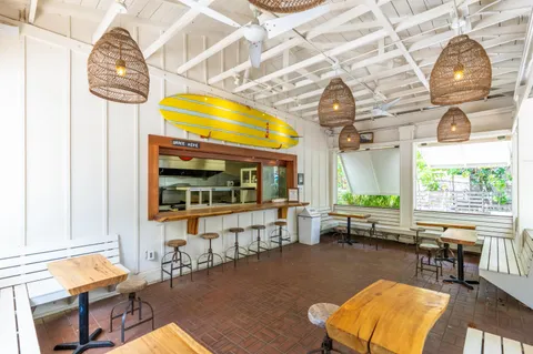 a living room with fireplace furniture and a large window