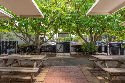a view of a patio with table and chairs and potted plants