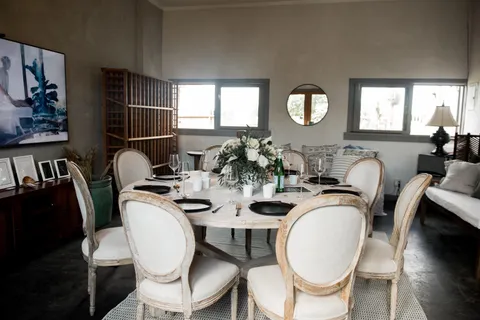 a dining room with furniture a rug and wooden floor