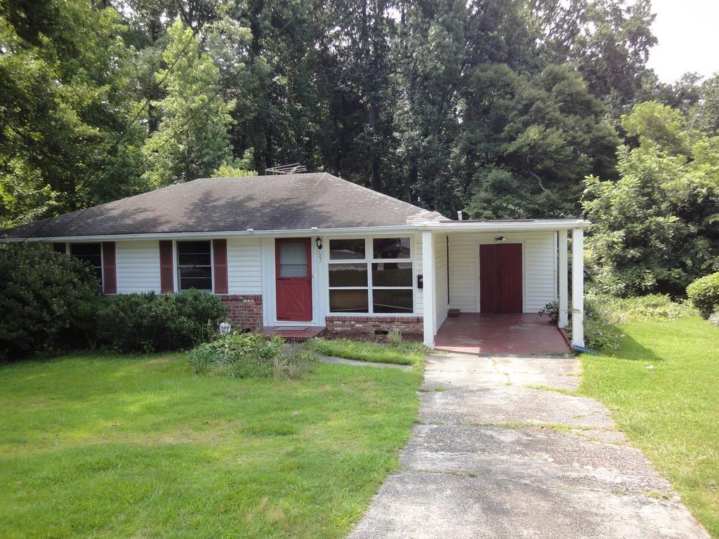 a front view of house with yard and green space