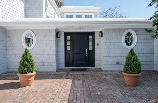 a view of a house with potted plants
