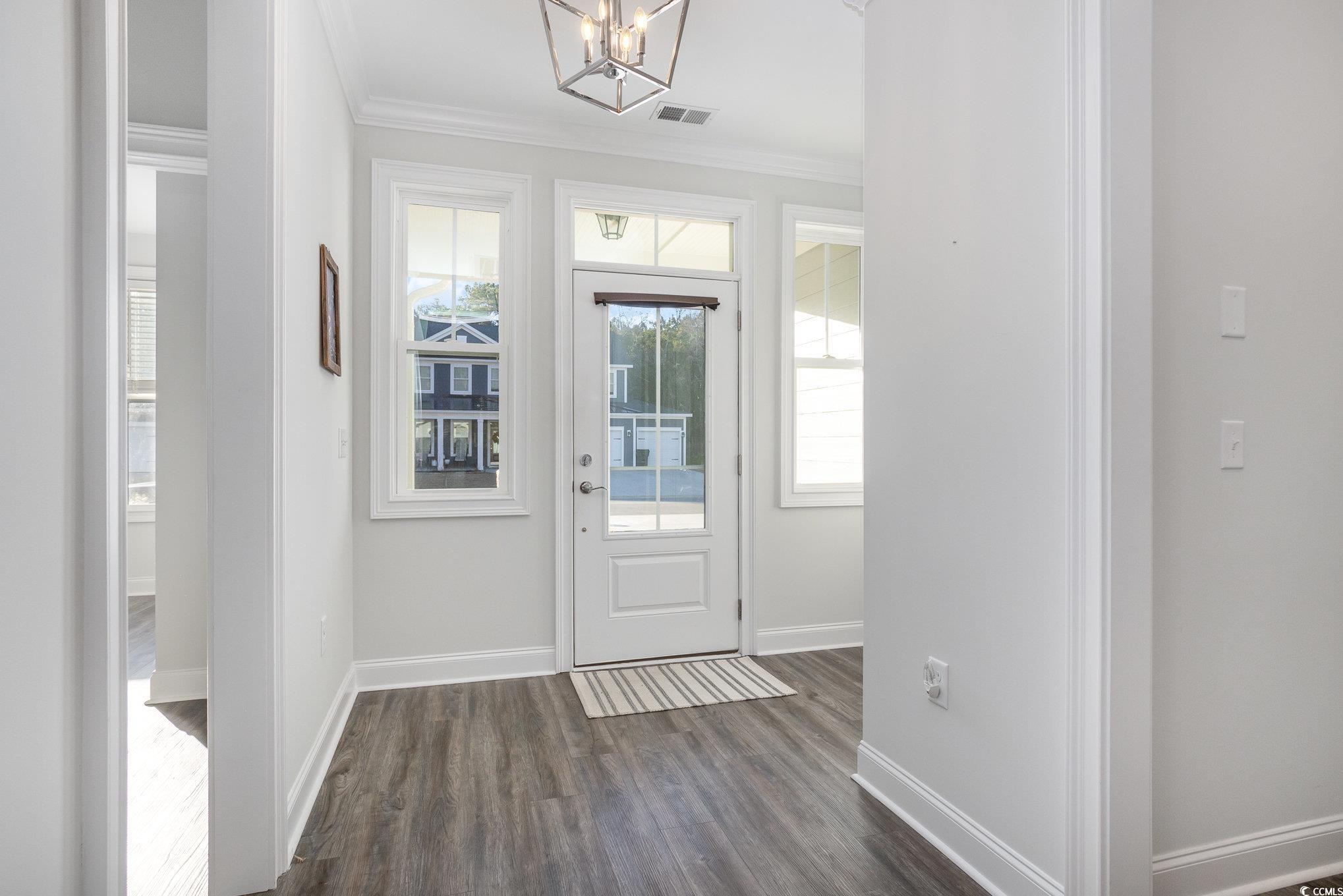 146 Caroline Court Murrells Inlet, SC 29576 - Photo 5 of 40 Foyer featuring ornamental molding, dark hardwood