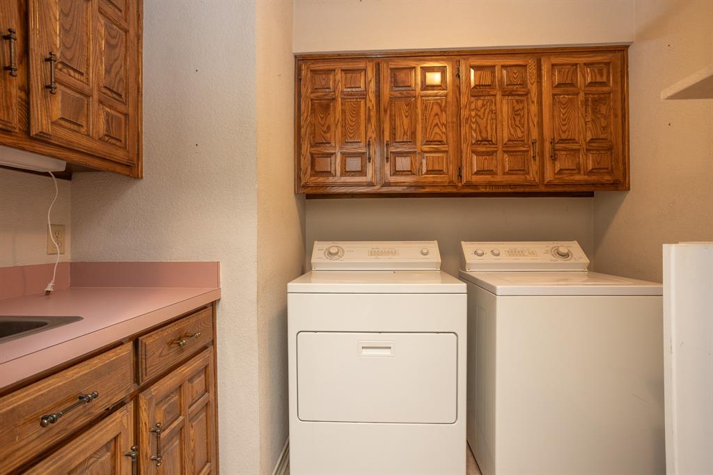 714 Mill Creek Road Lancaster, TX 75146 - Photo 11 of 27 Utility room has built-ins and sink plus extra storage on the right side. Washer and Dryer remain.