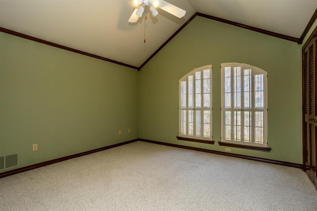 714 Mill Creek Road Lancaster, TX 75146 - Photo 17 of 27 Front bedroom has special window treatments, vaulted ceiing, fan, nice closet space, carpet.
