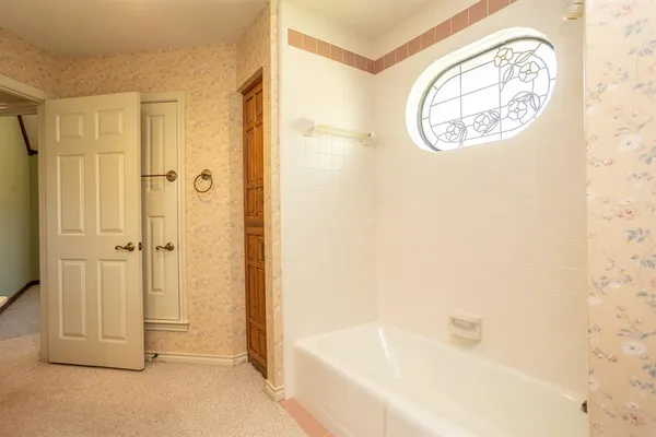 a bathroom with a bathtub and shower