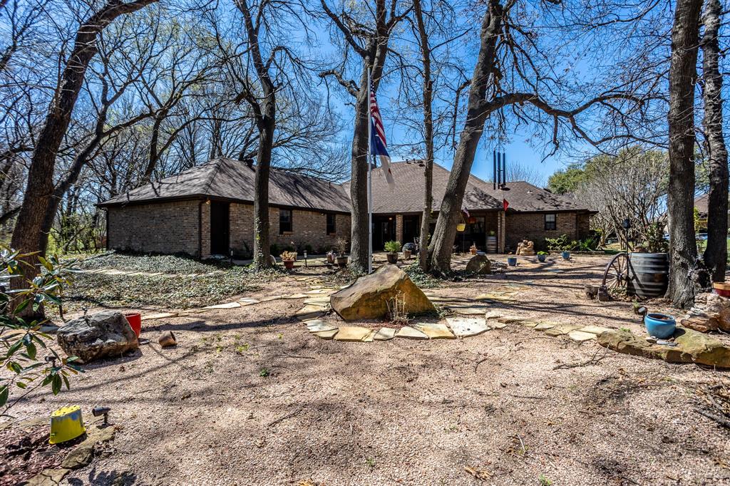 714 Mill Creek Road Lancaster, TX 75146 - Photo 24 of 27 View from back property line toward back of house. Enjoy the birds and squirrels that live along the tree line. Place to relax and enjoy the nature that is around you. Low up keep yard.