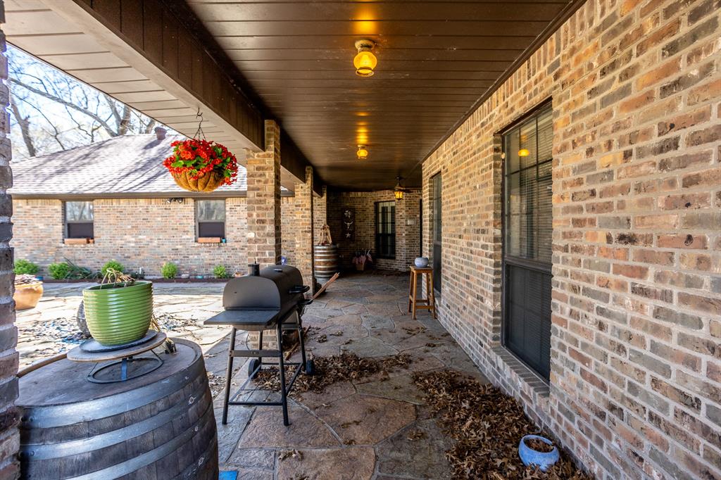 714 Mill Creek Road Lancaster, TX 75146 - Photo 26 of 27 Looking at long covered area of patio with low maintenance ceilings.
