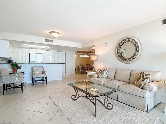 a living room with furniture and a clock