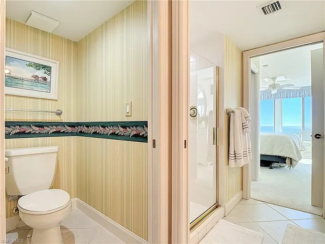 a bathroom with a toilet and a shower