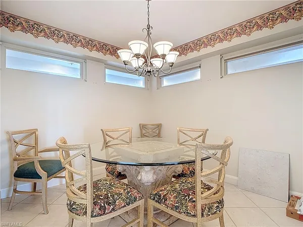 a view of a dining room with furniture and a chandelier