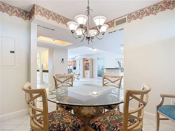 a view of a dining room with furniture and a chandelier