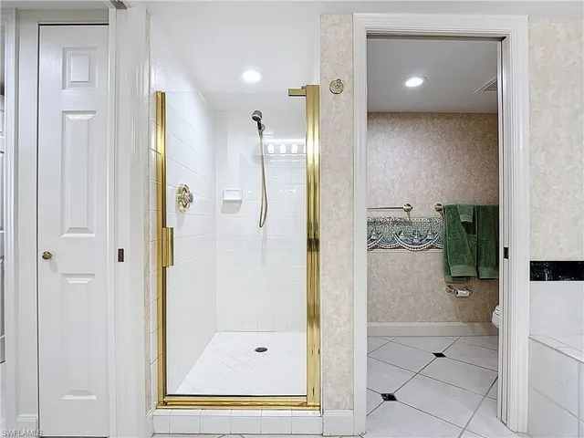 a bathroom with a glass shower door and a sink