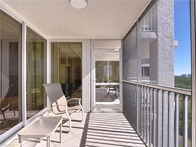 a view of a balcony with chair and glass door
