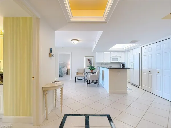a open kitchen with white cabinets and stainless steel appliances