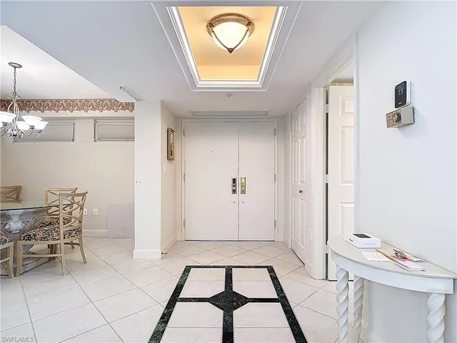 a view of a hallway with workspace and a window