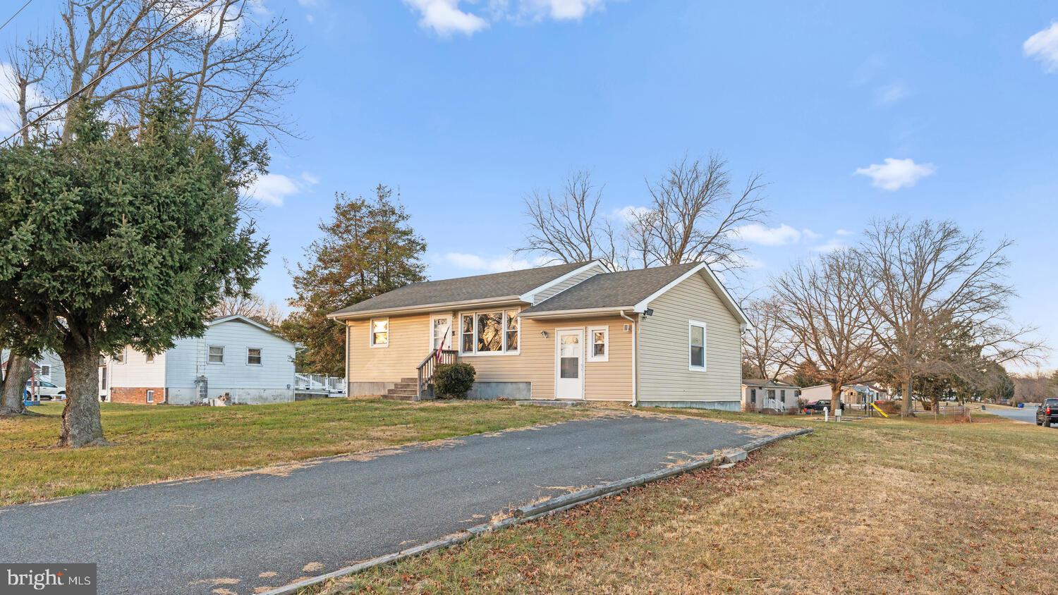 3999 Firetower Road Felton, DE 19943 - Photo 2 of 30 a view of white house with a big yard and large trees