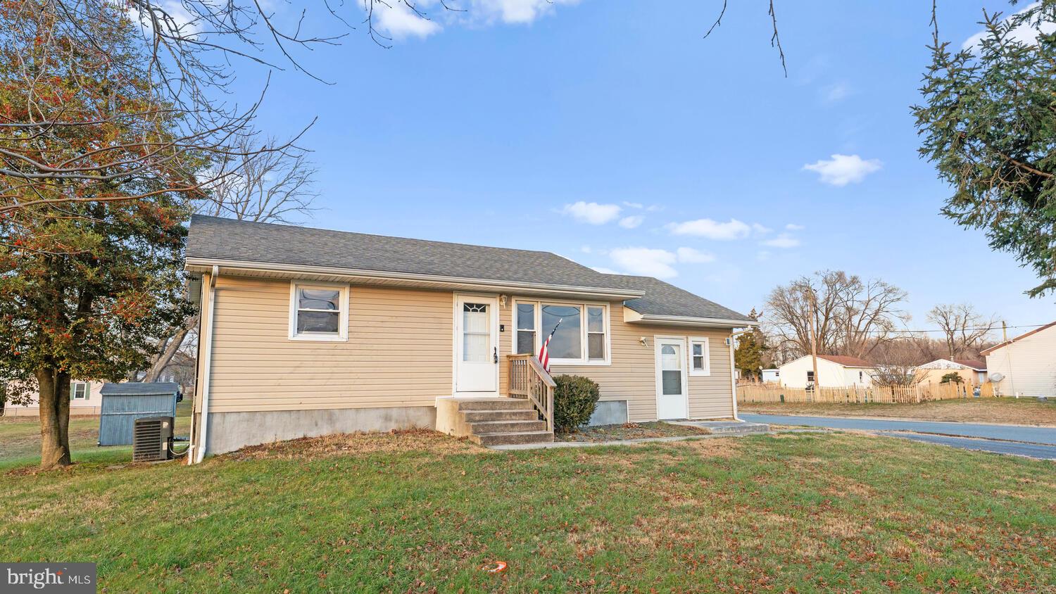 3999 Firetower Road Felton, DE 19943 - Photo 3 of 30 a front view of a house with a garden and yard