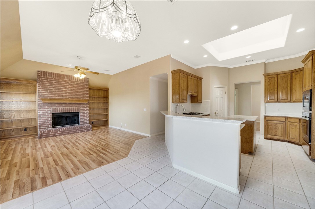 11901 Jess Drive Austin, TX 78737 - Photo 11 of 36 a large kitchen with cabinets and a fireplace