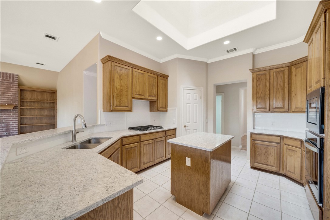 11901 Jess Drive Austin, TX 78737 - Photo 12 of 36 a kitchen with stainless steel appliances granite countertop a sink stove and refrigerator