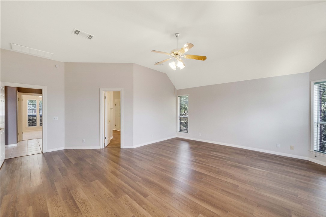 11901 Jess Drive Austin, TX 78737 - Photo 15 of 36 a view of an empty room with window and wooden floor