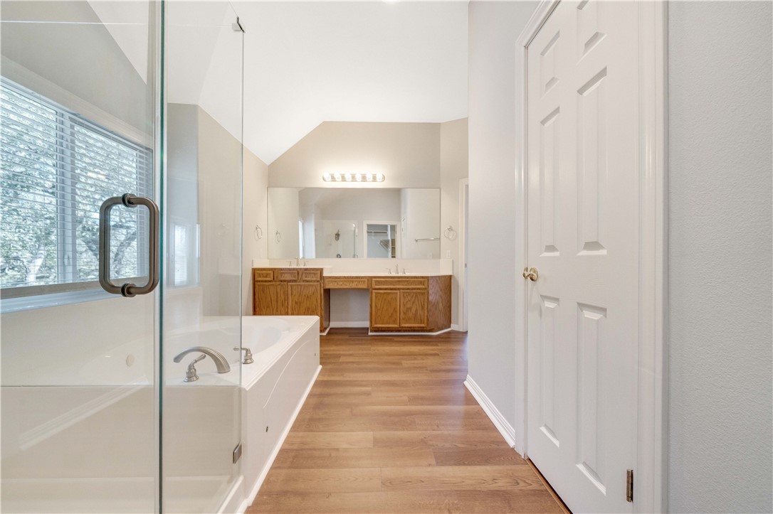 11901 Jess Drive Austin, TX 78737 - Photo 17 of 36 a en suite bathroom with a double vanity sink and a mirror