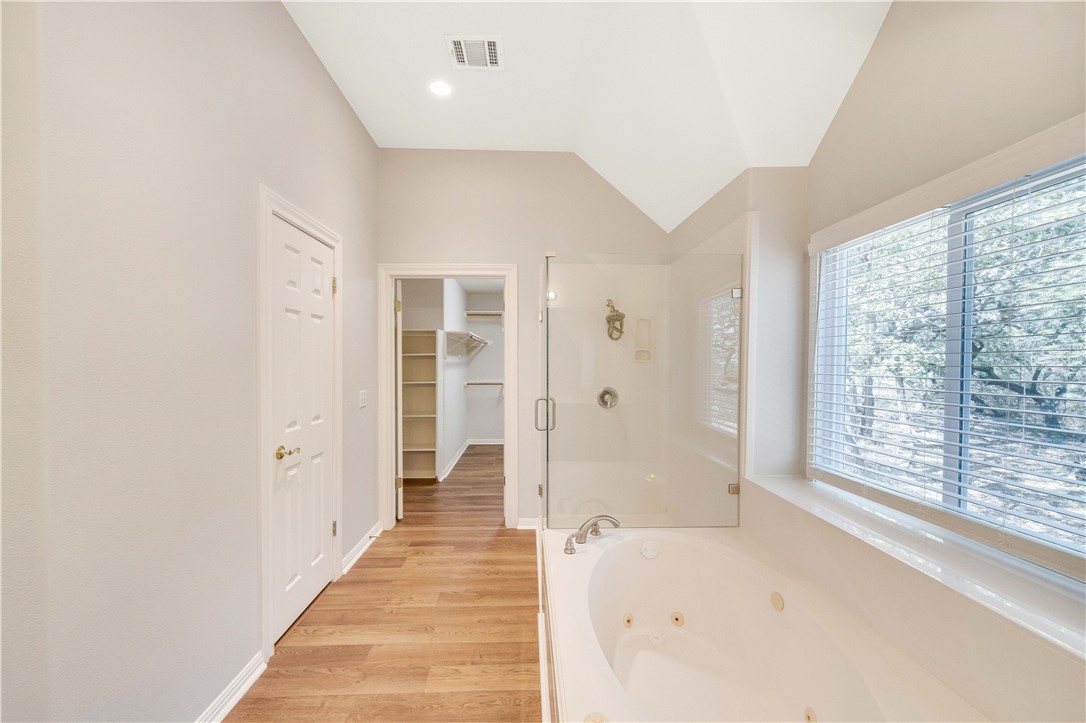 11901 Jess Drive Austin, TX 78737 - Photo 19 of 36 a view of a hallway with wooden floor and windows