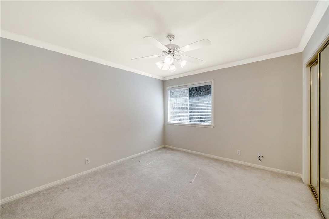 11901 Jess Drive Austin, TX 78737 - Photo 22 of 36 an empty room with a window and a ceiling fan