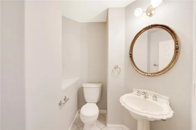 a bathroom with a toilet a sink and a mirror