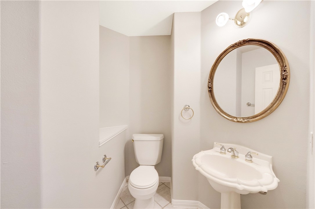 11901 Jess Drive Austin, TX 78737 - Photo 27 of 36 a bathroom with a toilet a sink and a mirror