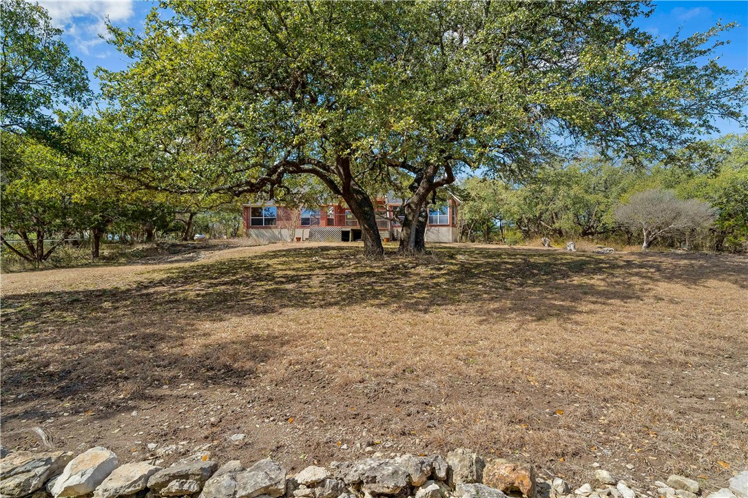 11901 Jess Drive Austin, TX 78737 - Photo 31 of 36 a view of dirt yard with large trees