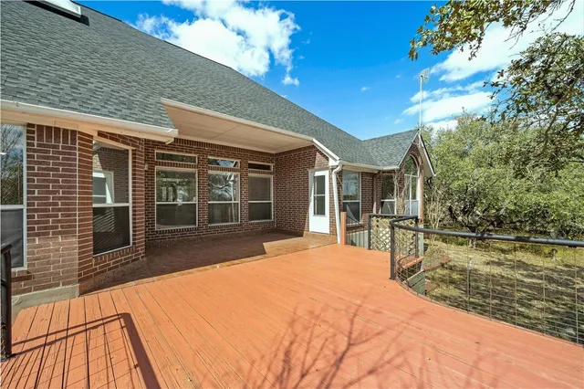 a house view with swimming pool in front of it
