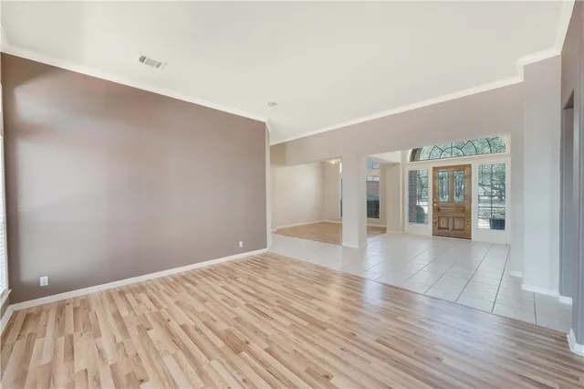 wooden floor in an empty room with a window