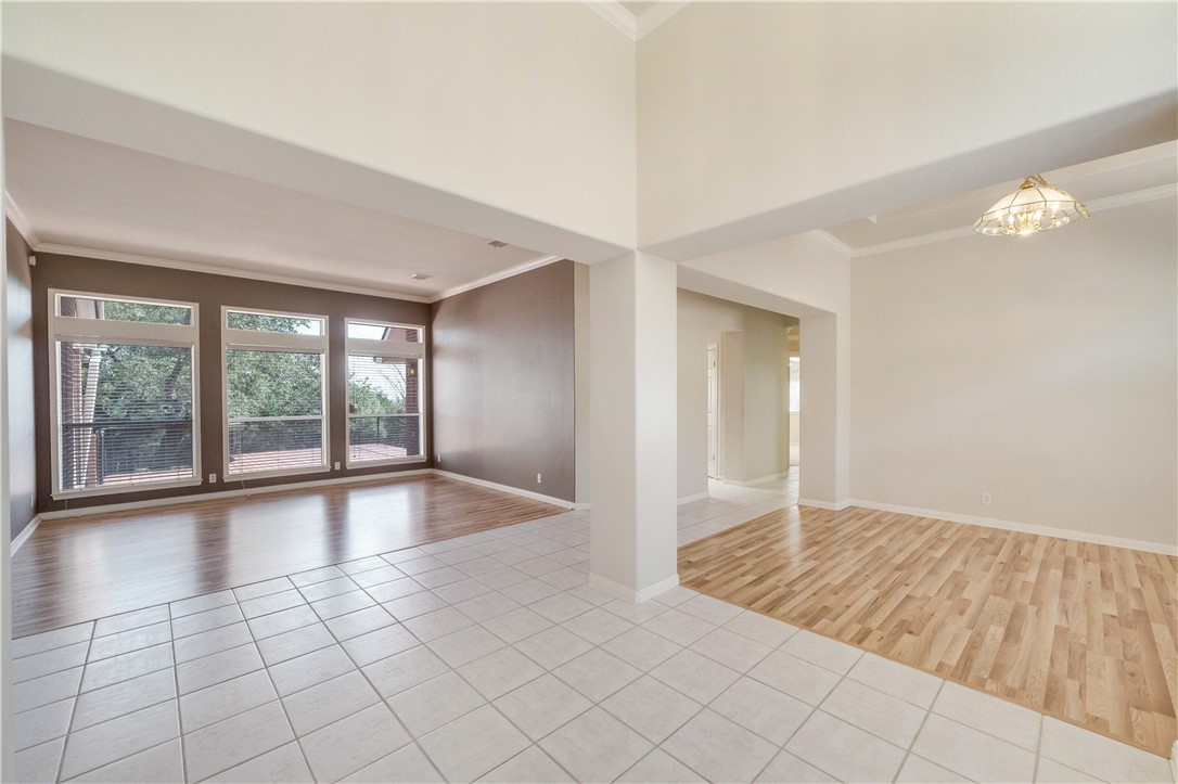 11901 Jess Drive Austin, TX 78737 - Photo 7 of 36 a view of an empty room with window and chandelier fan