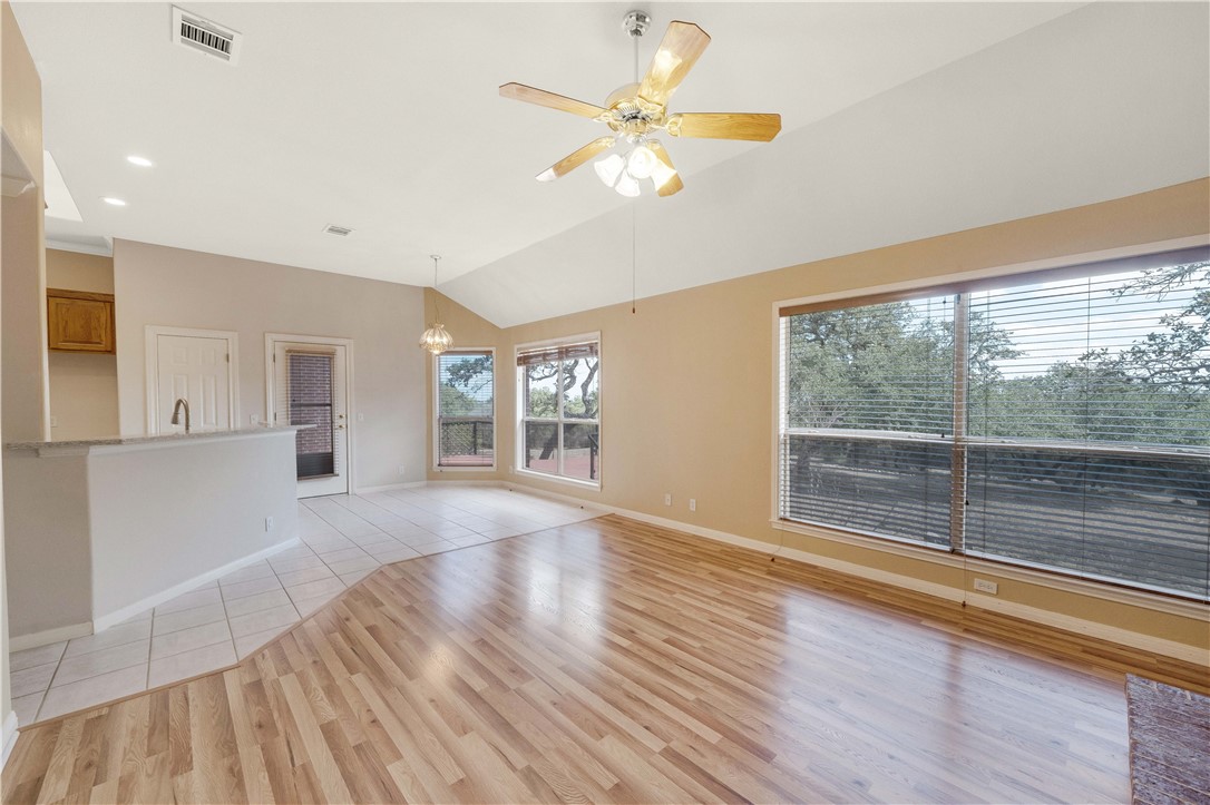 11901 Jess Drive Austin, TX 78737 - Photo 9 of 36 a view of an empty room with wooden floor and a window