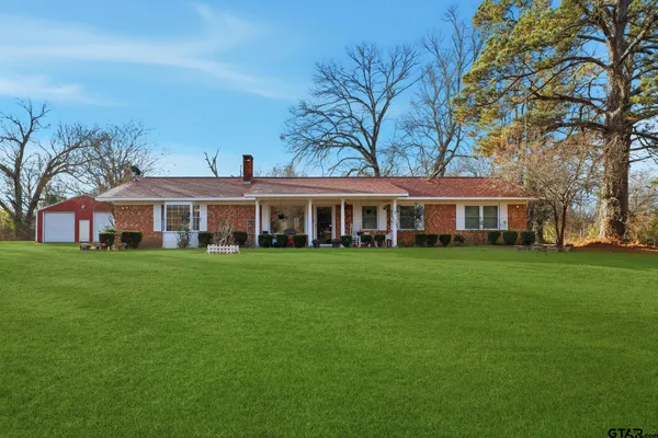 a front view of a building with a garden