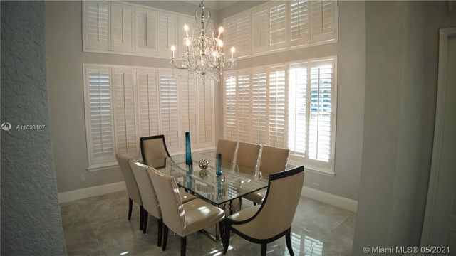 a dining room with furniture and chandelier