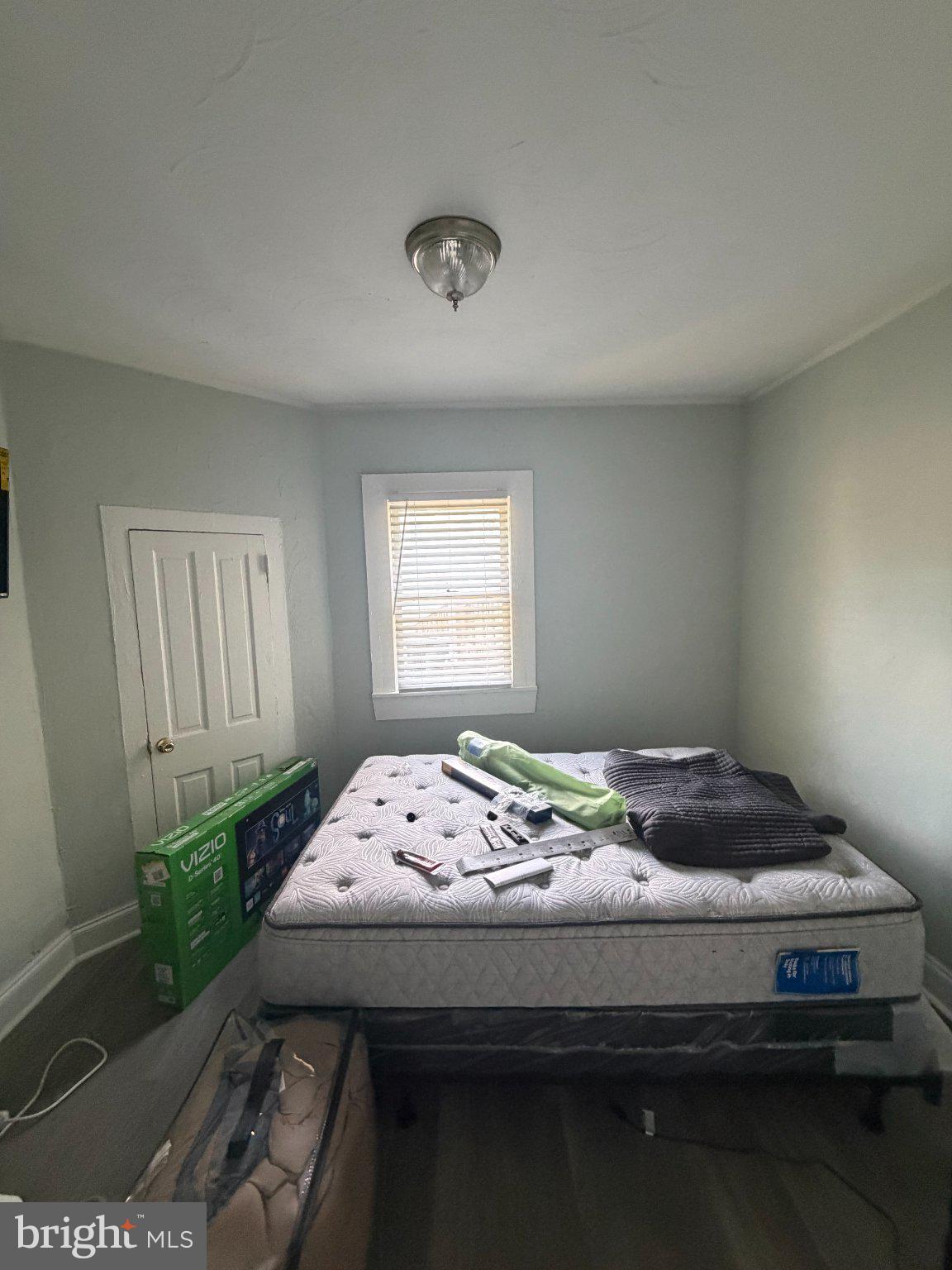 1114 North Mallory Street Hampton, VA 23663 - Photo 3 of 9 a bed sitting in a bedroom next to a window