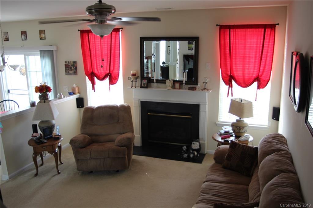 7539 Bluff Point Lane Denver, NC 28037 - Photo 11 of 30 a living room with furniture a fireplace and a flat screen tv